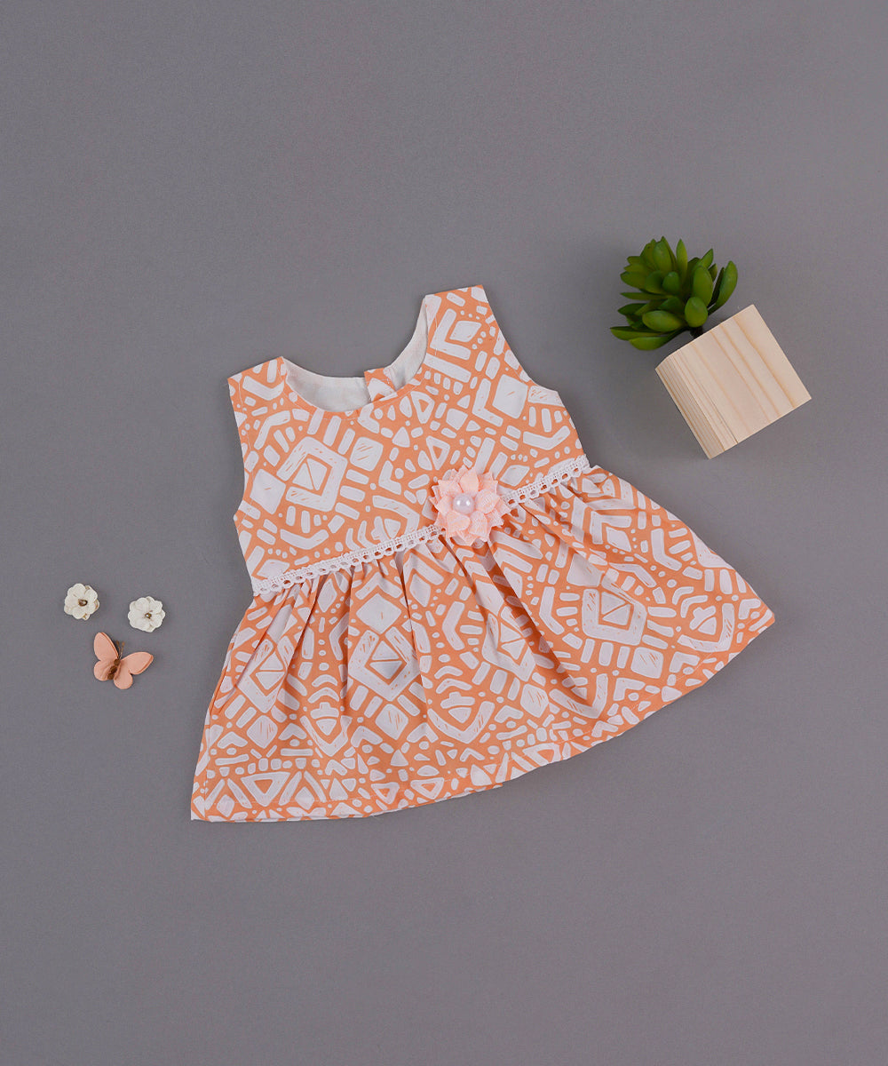 🧡 Peach Printed Baby Frock with Lace & Flower Charm